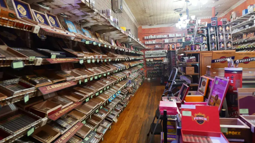 Walk in humidor aisle at Edward's, open cedar cigar boxes on stepped shelving